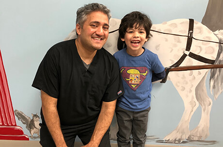 Dr. with patient in front of horse mural